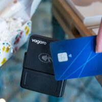 A hand is paying with a credit card.