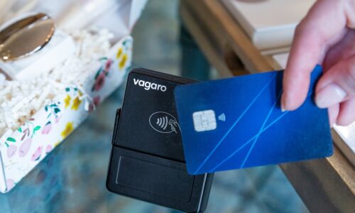 A hand is paying with a credit card.